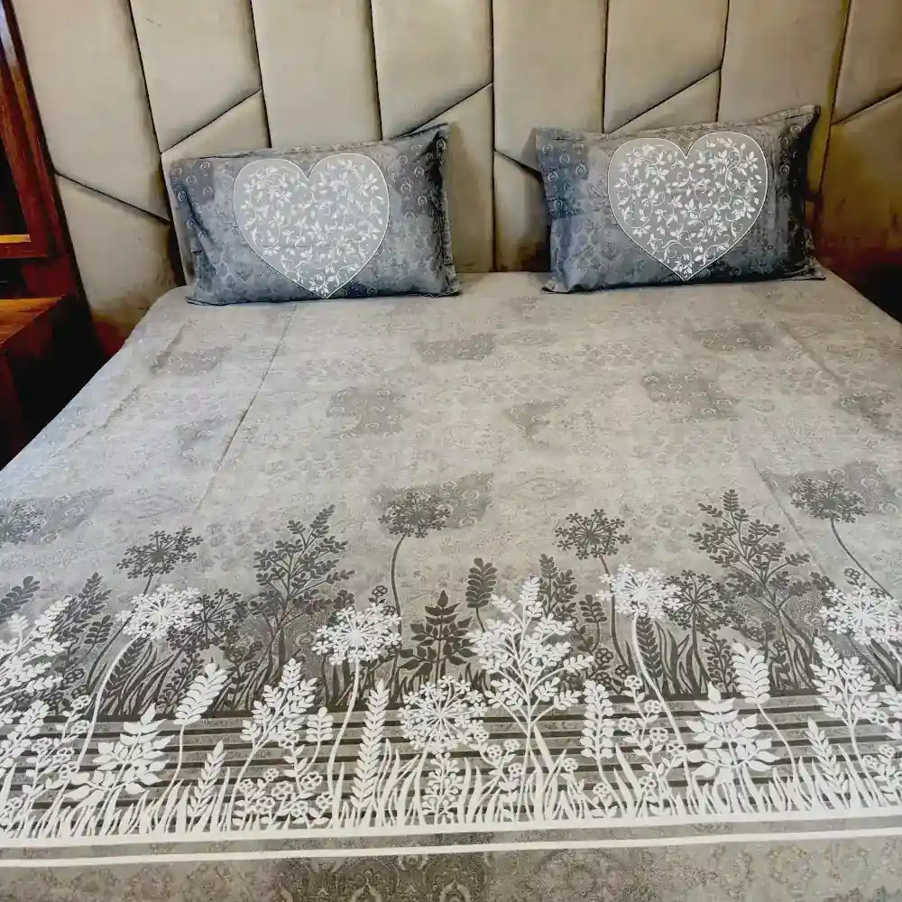 modern grey printed bedsheet with botanical pattern and heart pillow covers